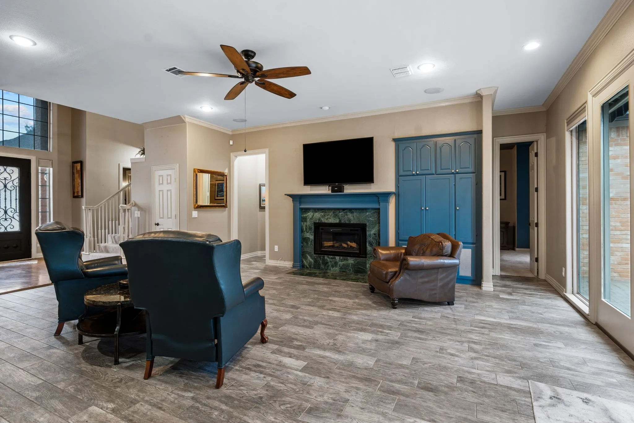 Living area featuring wood-finish tile flooring and a ceiling fan