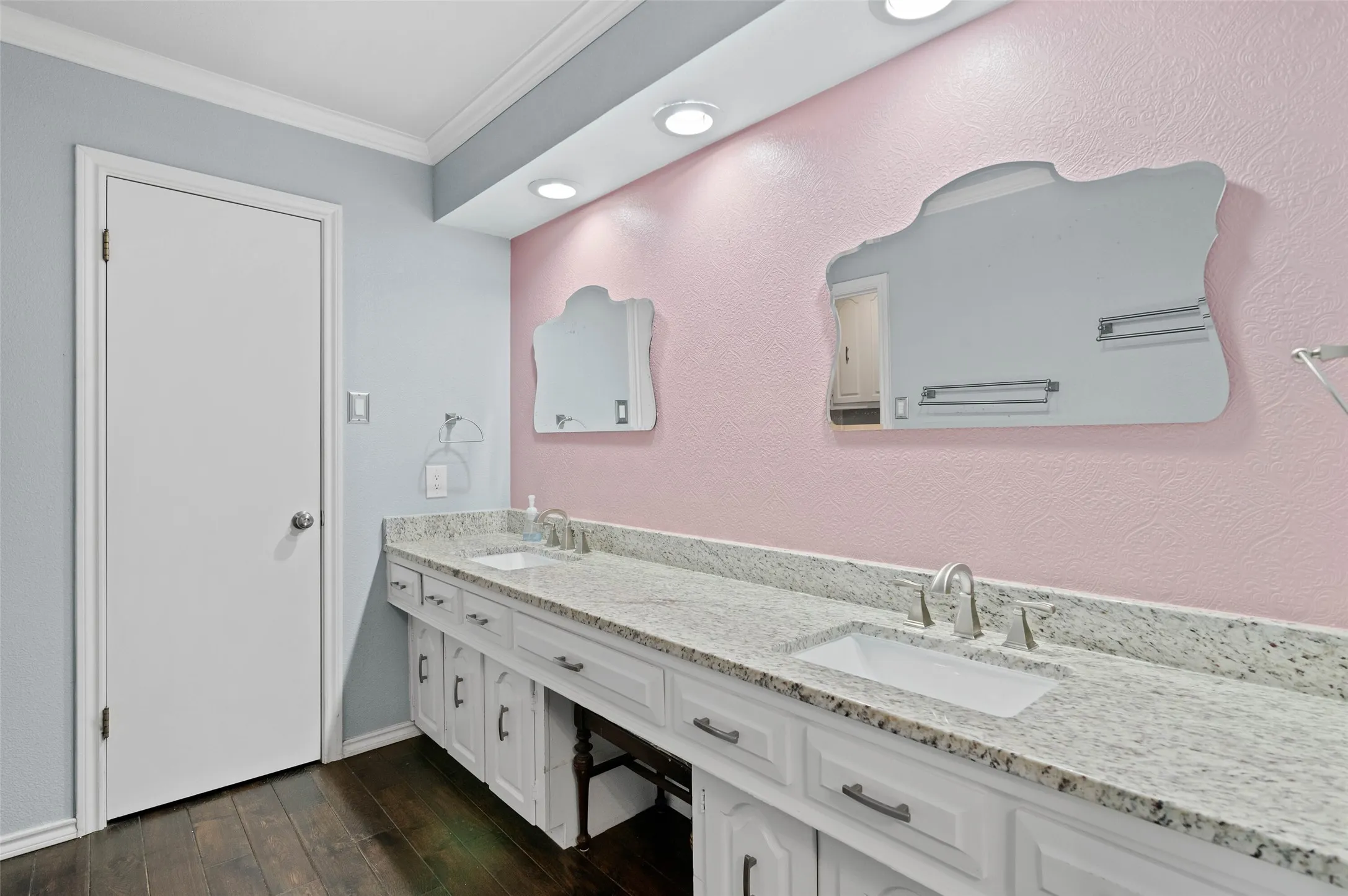 Primary bathroom with dual sinks and granite counters