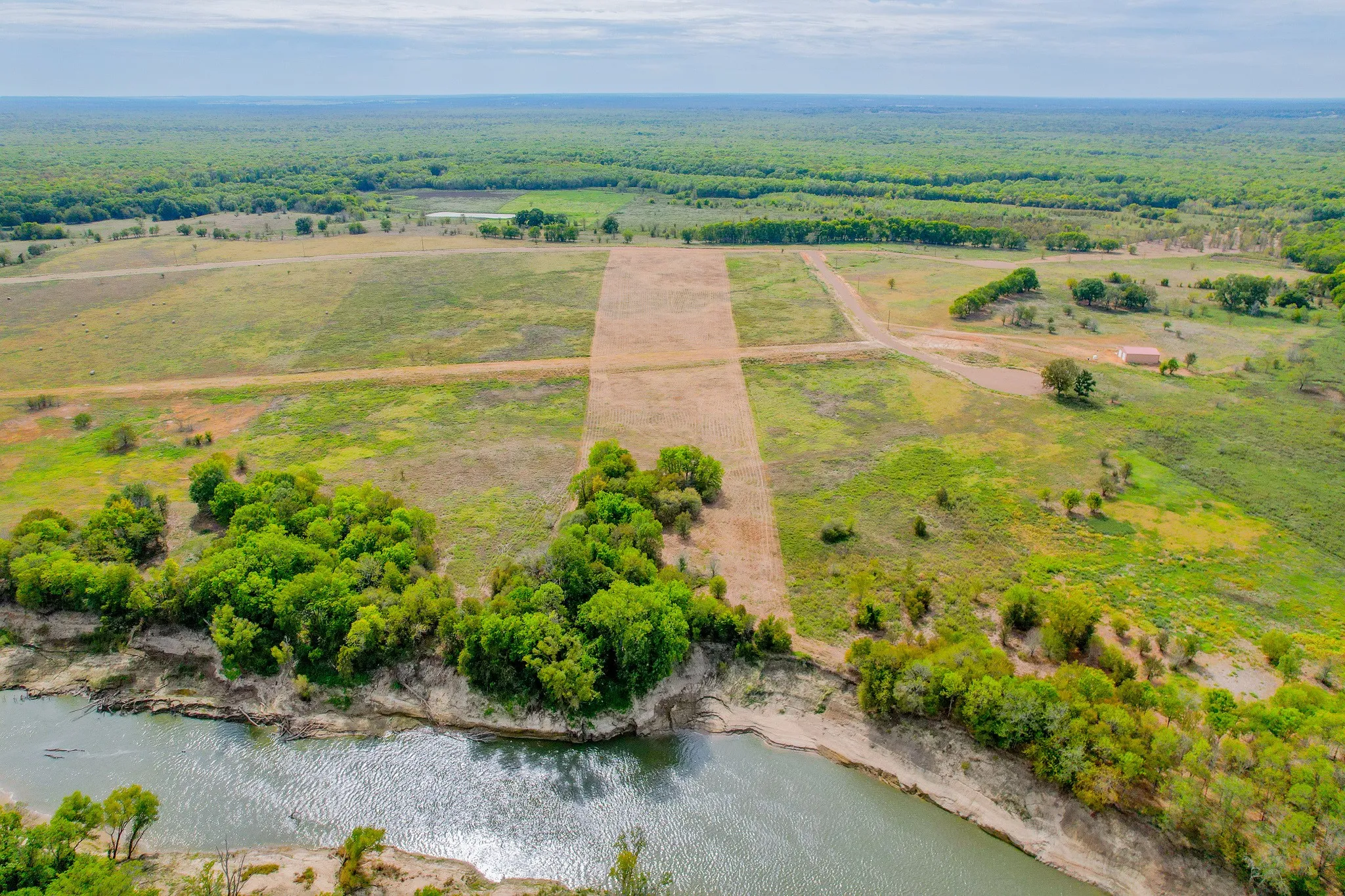 Design a custom barndominium with river views, privacy, and access to the best of East Texas living.