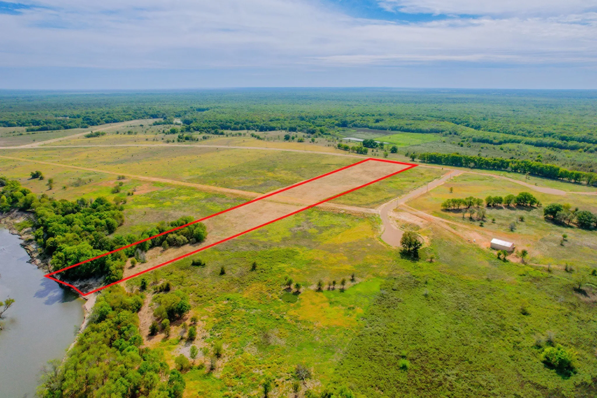 Wide open Texas skies frame this peaceful 10-acre riverfront property.