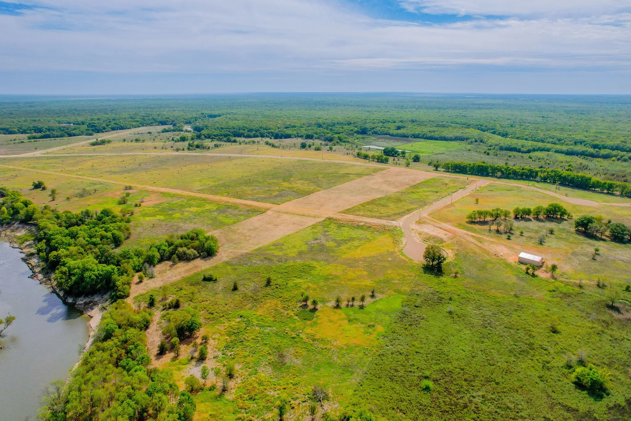 Mostly cleared land offers flexibility for a barndominium, ranch retreat, or country homesite.