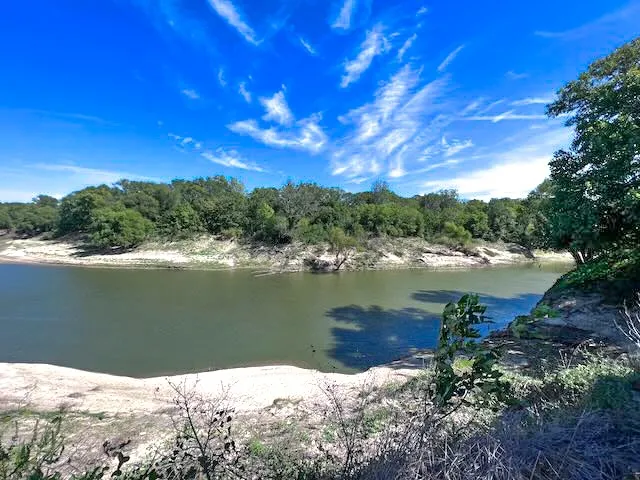 Build your dream barndominium overlooking the Trinity River with plenty of room for animals and outdoor living.