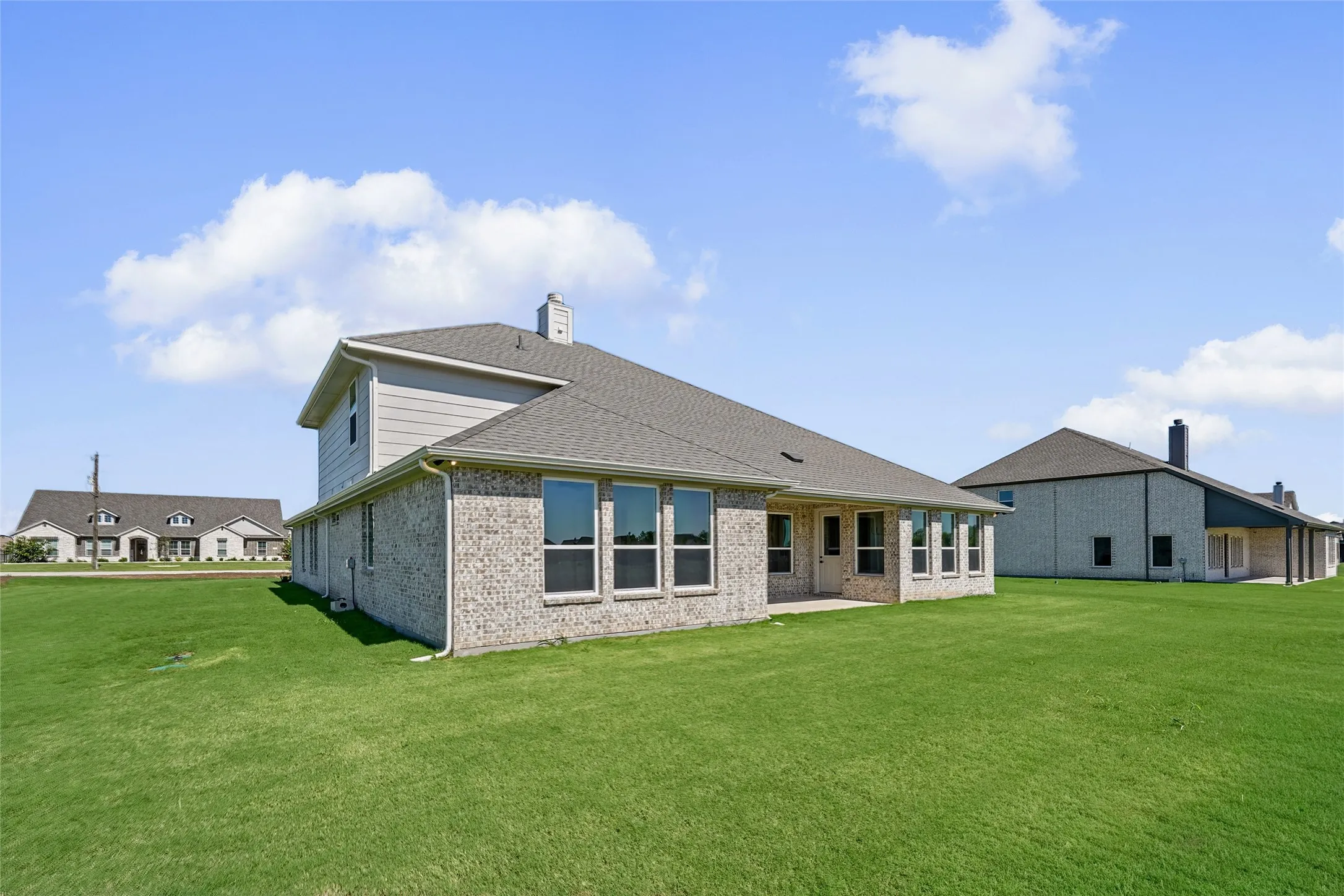 Light brick exterior with gray siding accents