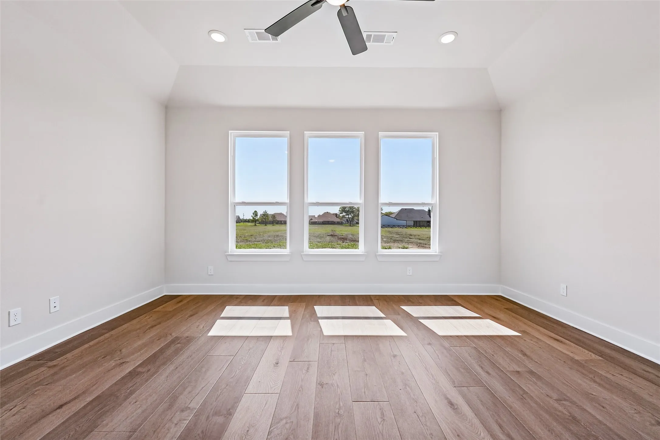 Vaulted ceiling with recessed lighting and ceiling fan