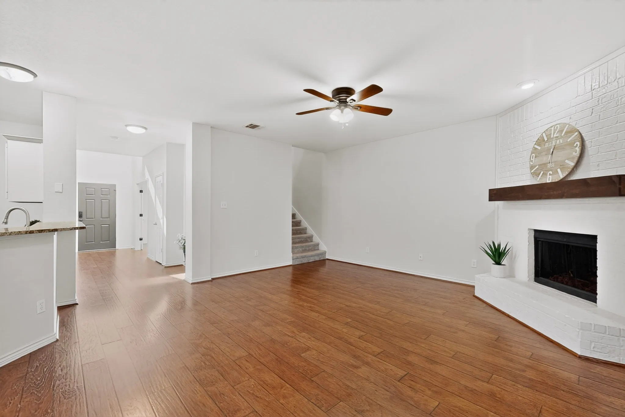 This spacious living room has a gas fireplace and overlooks the kitchen and backyard.
