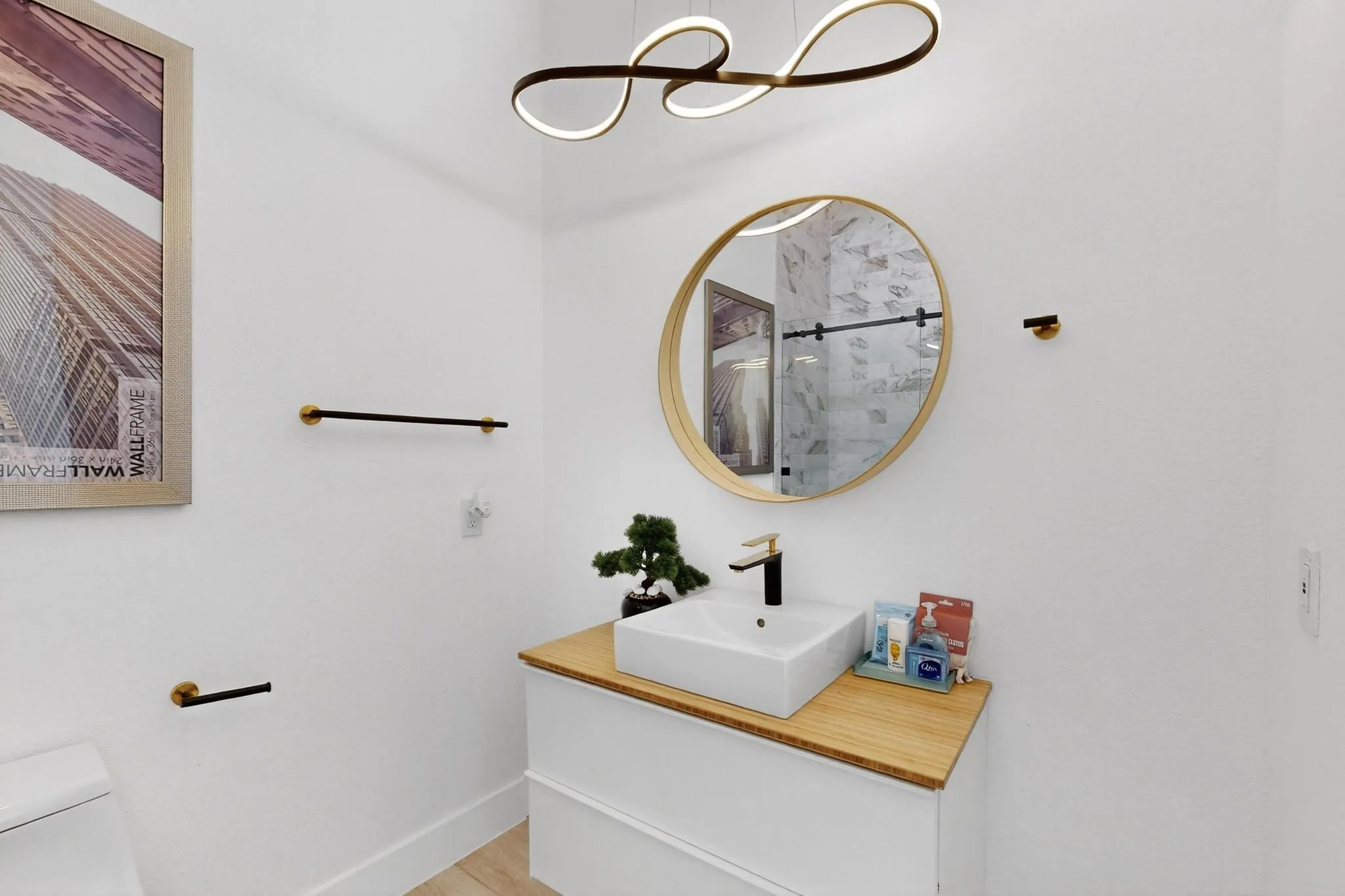 Modern vanity with a rectangular vessel sink, gold-finish faucet, and wood-finish countertop