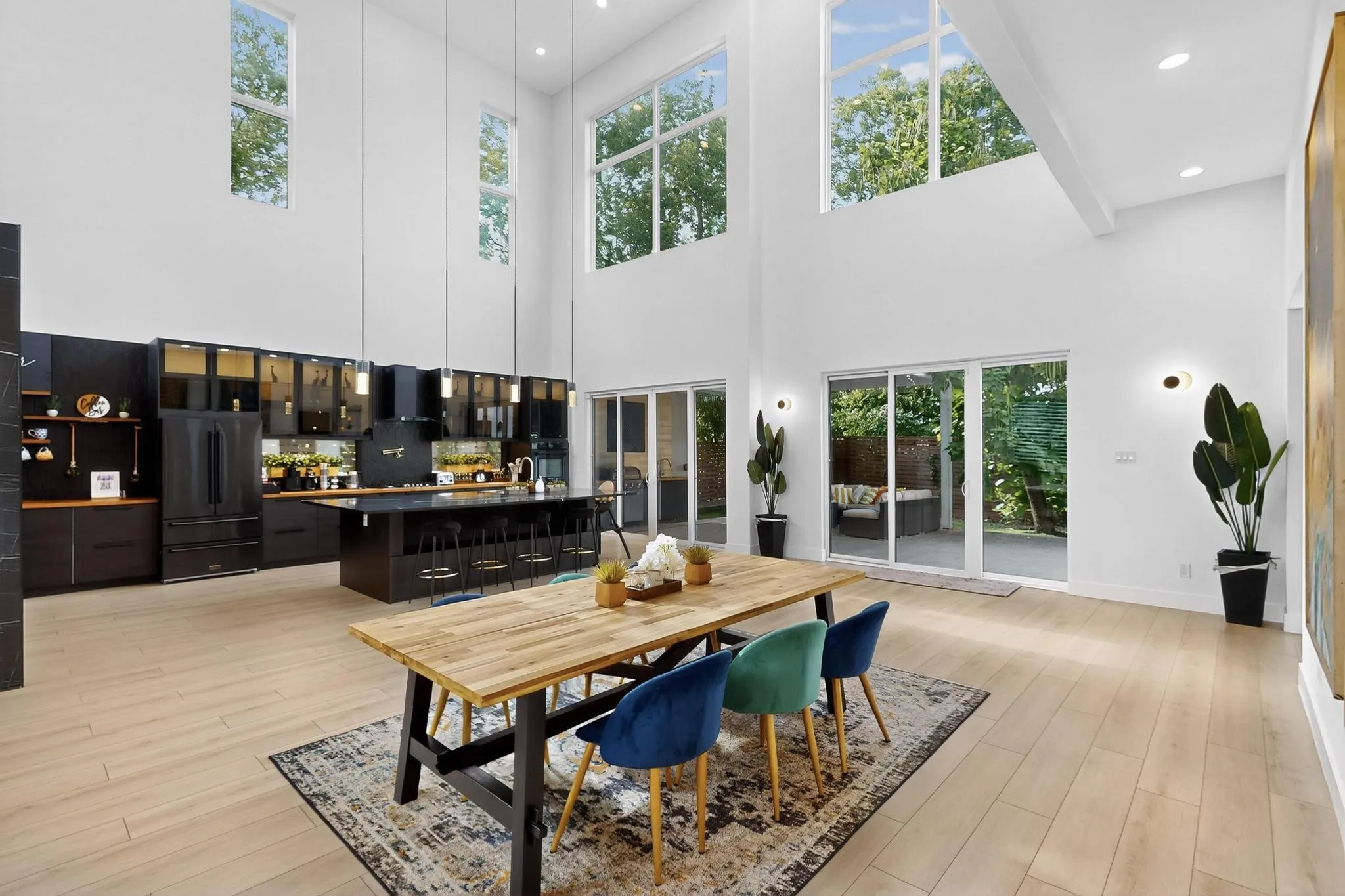 Open-concept living area with soaring ceilings and light wood-finish flooring
