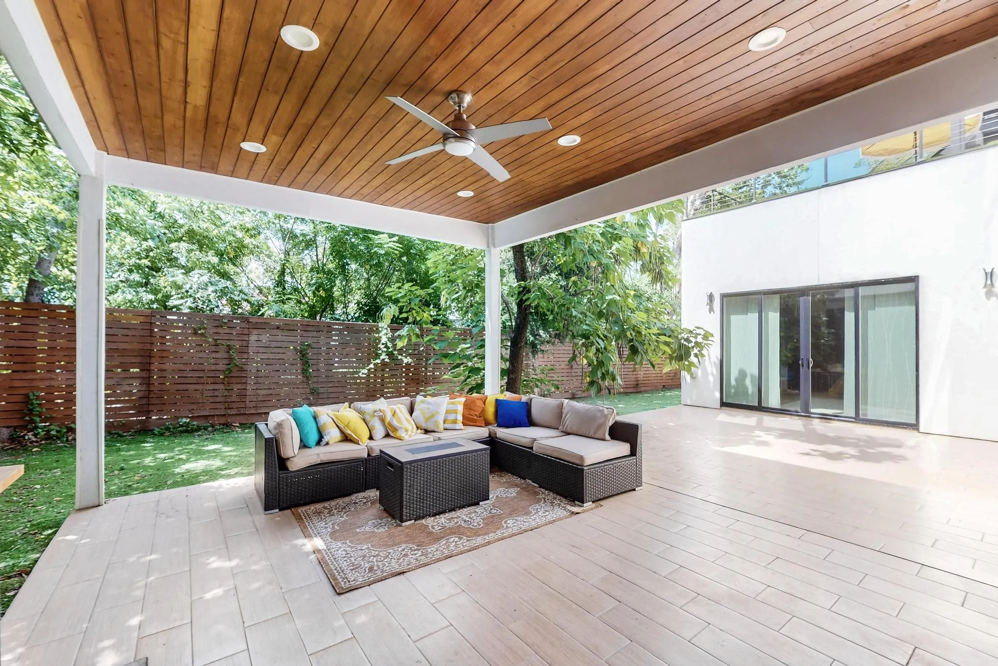 Spacious covered patio featuring a wood-finish ceiling, recessed lighting, and a ceiling fan
