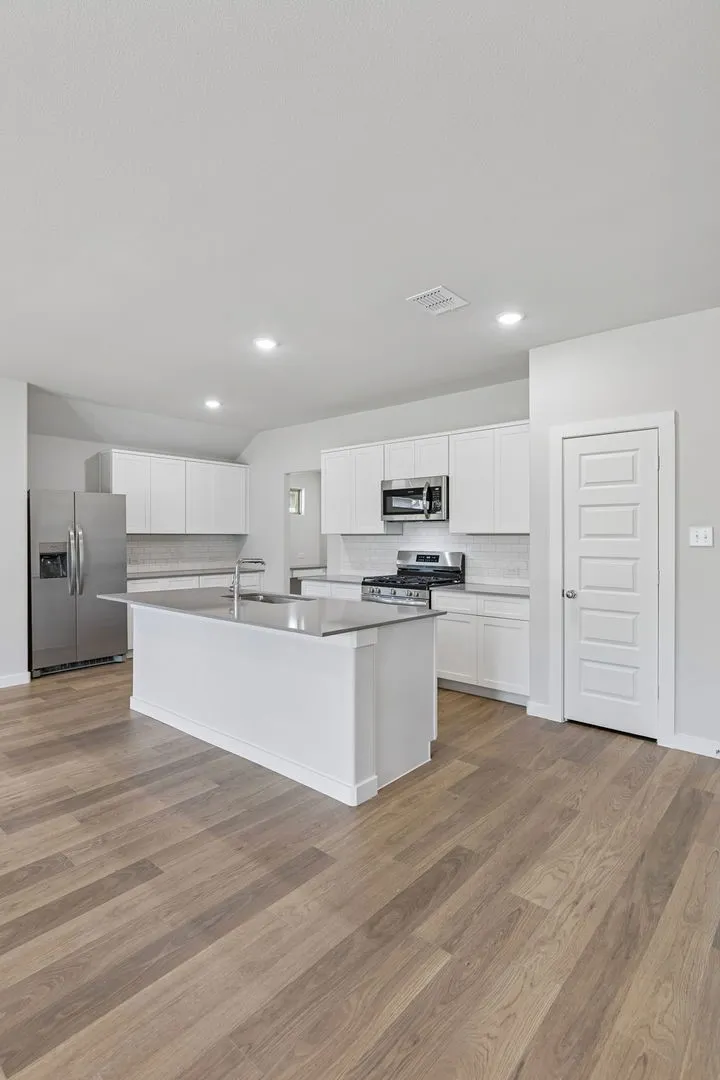 Kitchen in the Harrison home plan by Trophy Signature Homes – REPRESENTATIVE PHOTO