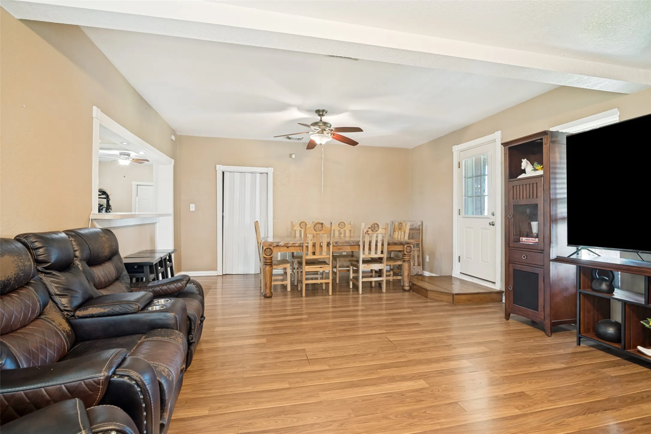 Open-concept living space featuring wood-finish flooring throughout