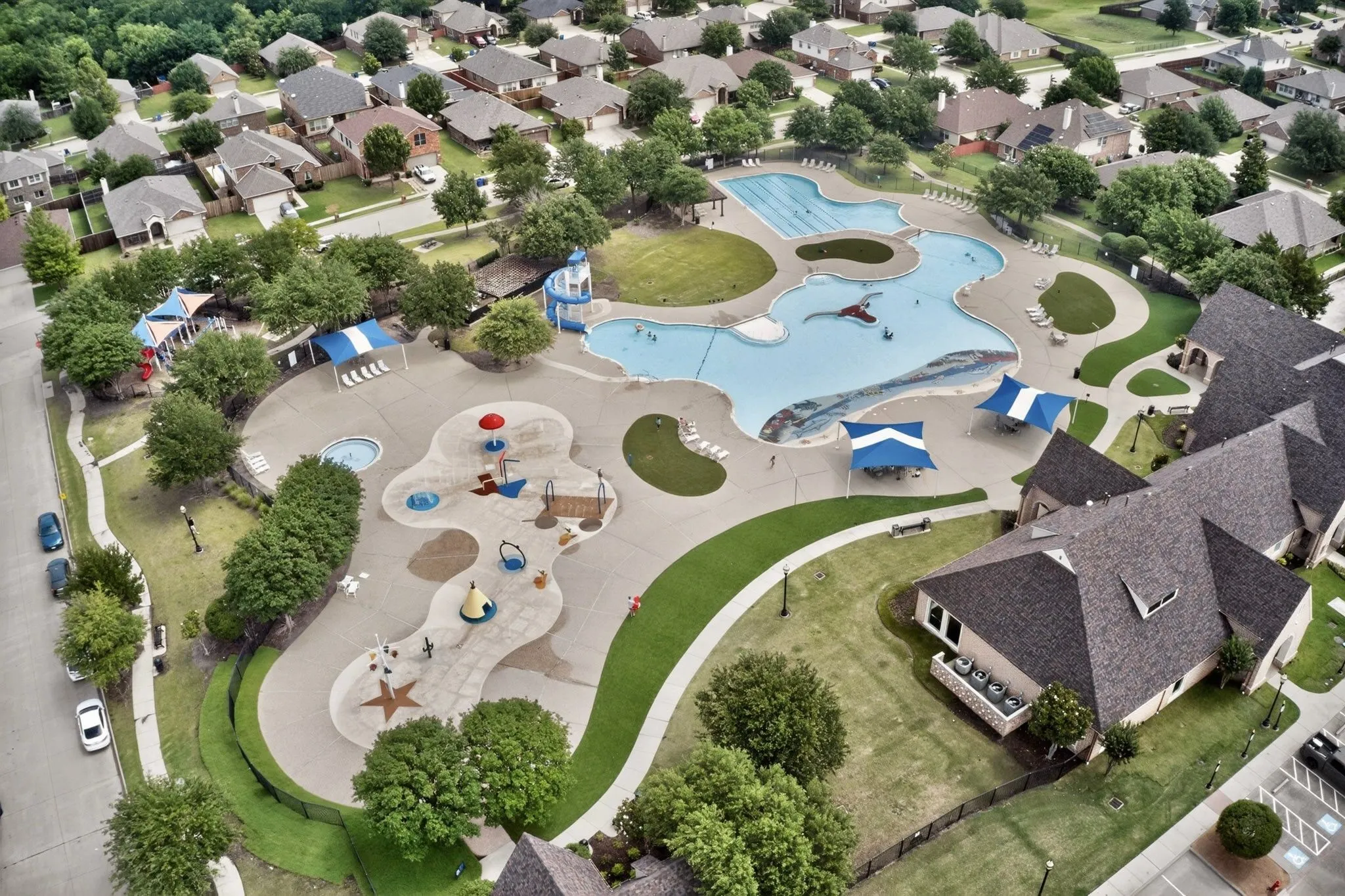 Expansive green lawn with established landscaping and a perimeter privacy fence