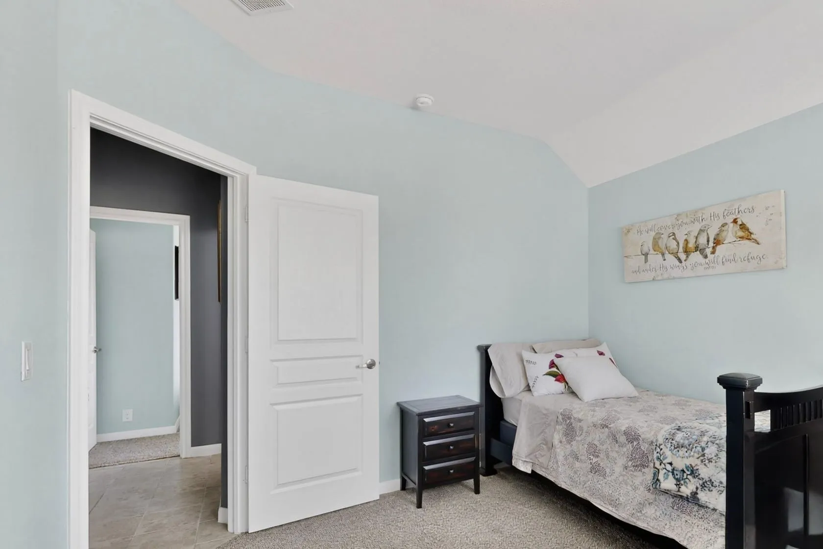Bedroom featuring a vaulted ceiling and light blue walls