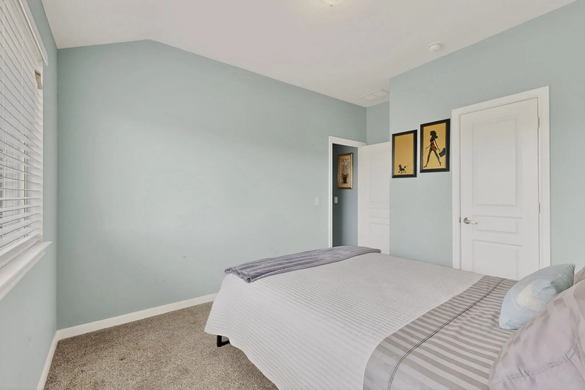 Neutral-toned carpeting and light blue walls create a serene atmosphere