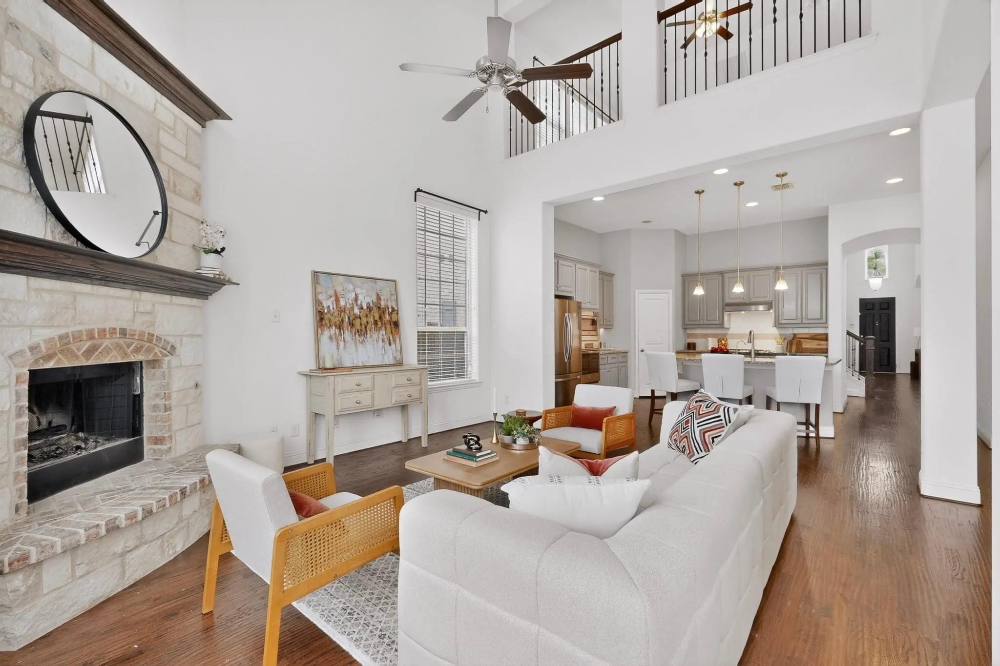 Bright living room showcasing a fireplace and a ceiling fan, creating a welcoming space.