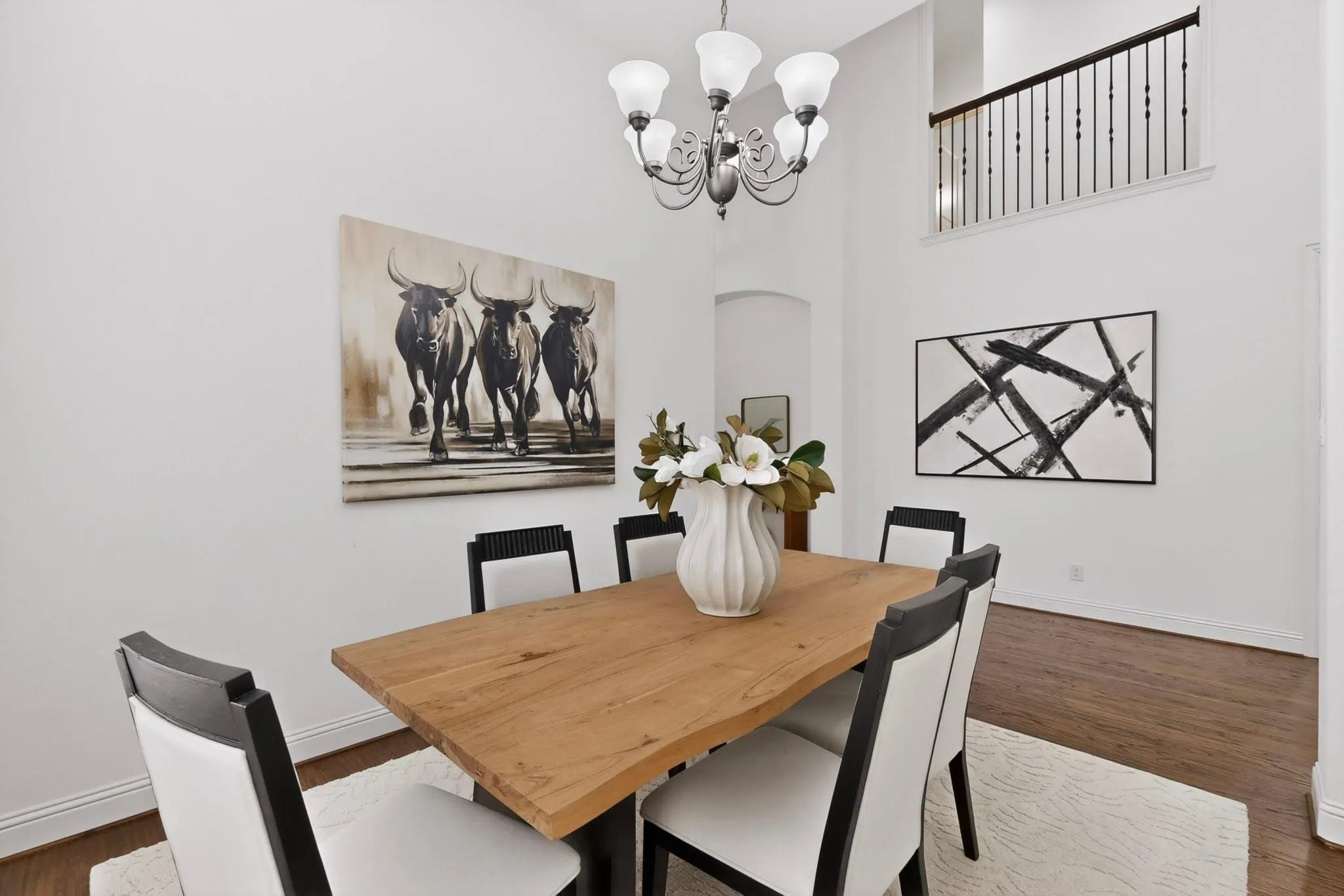 A bright dining area with a stylish chandelier, inviting for gatherings or meals.