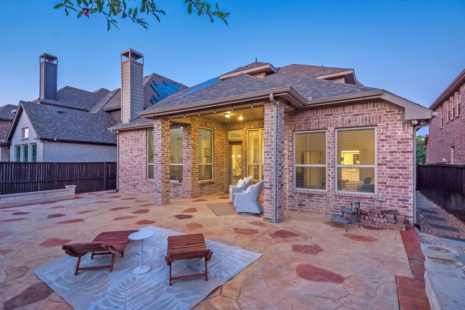 A charming patio with stylish wooden lounge chairs, inviting for relaxing evenings outdoors.