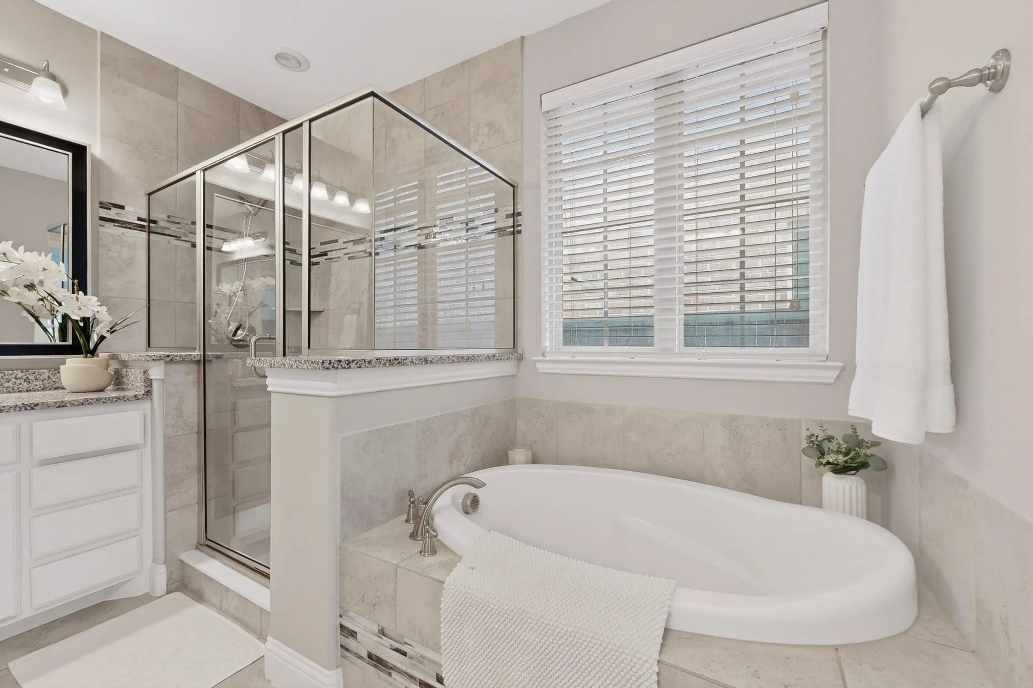 A spacious bathroom with a separate shower and tub, showcasing modern fixtures and a clean design.
