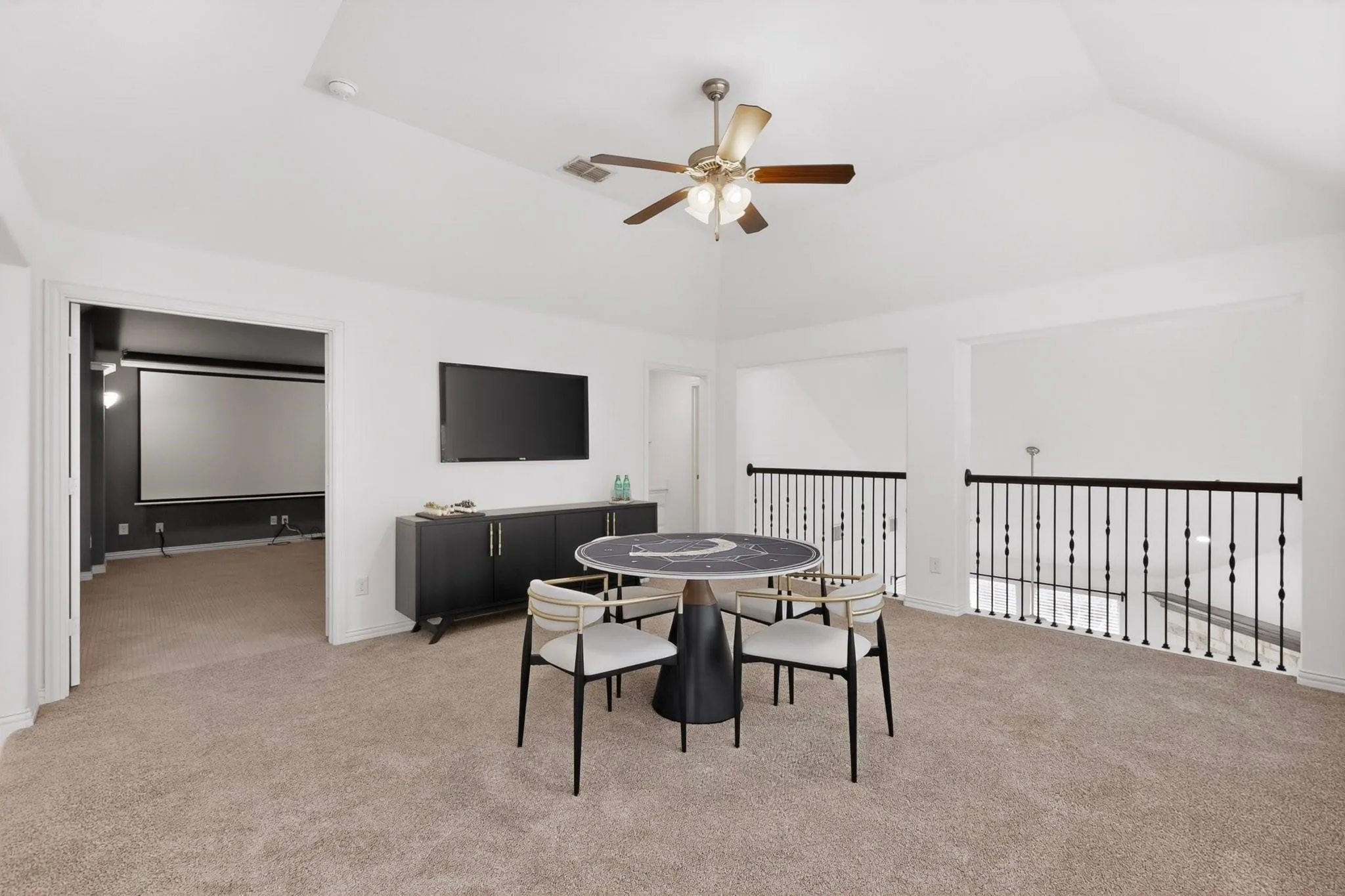 A spacious den with a ceiling fan, creating a comfortable space.