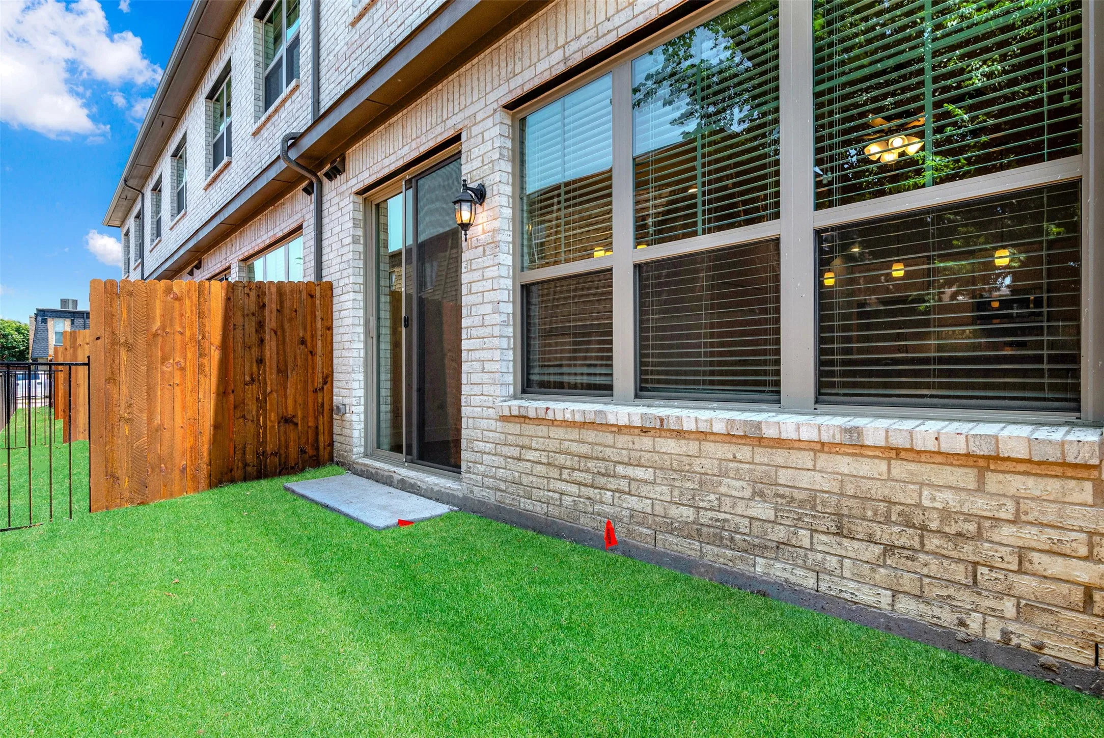 All units have small grassy fenced area off living area.