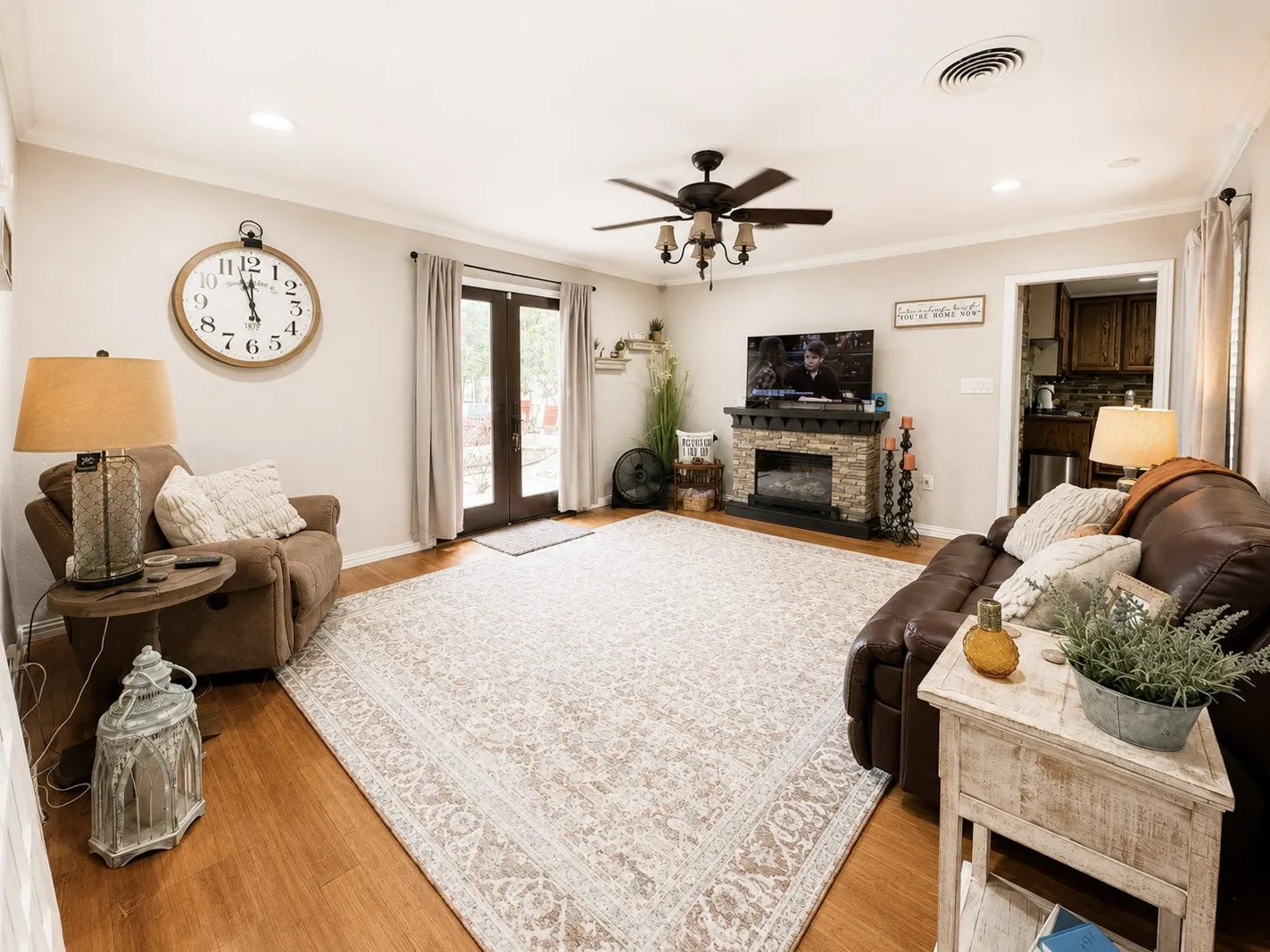 Living area featuring wood-finish flooring, recessed lighting, and a ceiling fan with light kit