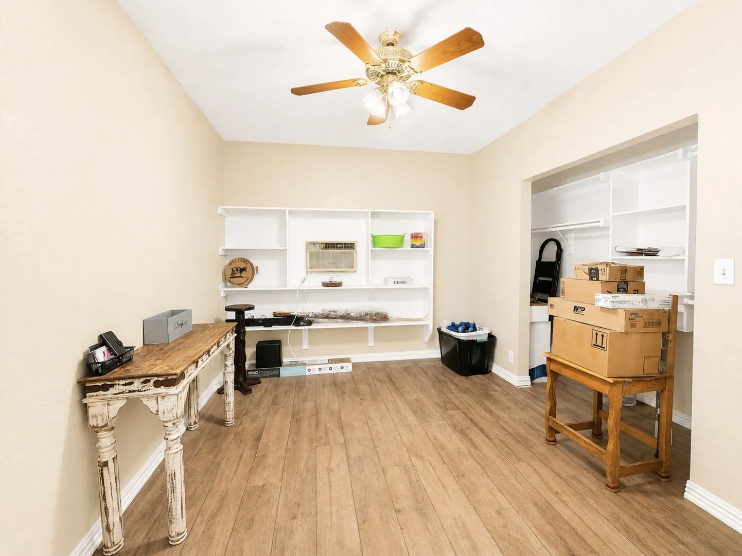 Bonus room or 5th bedroom. Spacious interior room featuring wood-finish flooring, vaulted ceiling, and a ceiling fan with light fixture