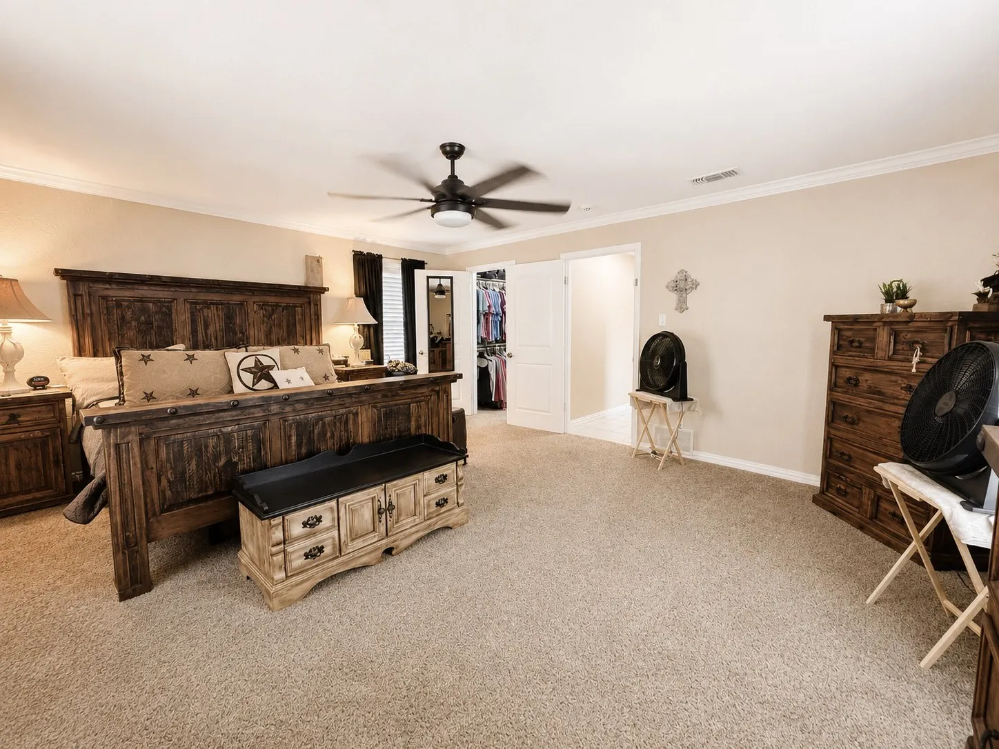 Primary Bedroom, Spacious carpeted room featuring a ceiling fan, crown molding, and light-toned walls