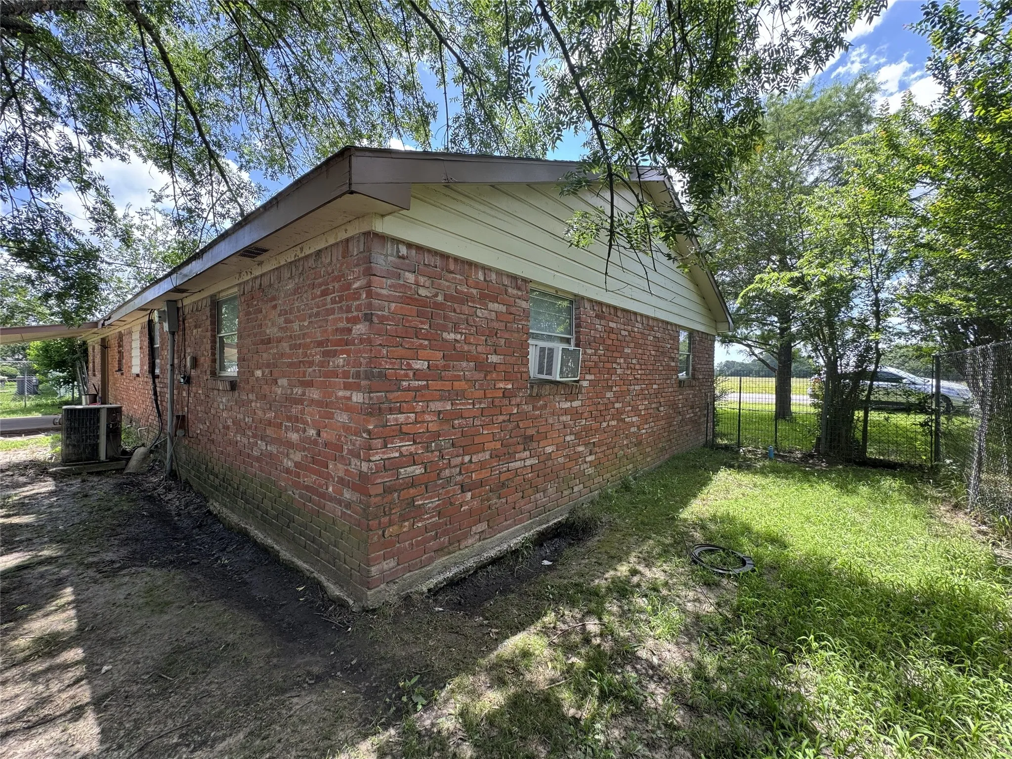 Brick exterior with light-colored siding and a covered entry