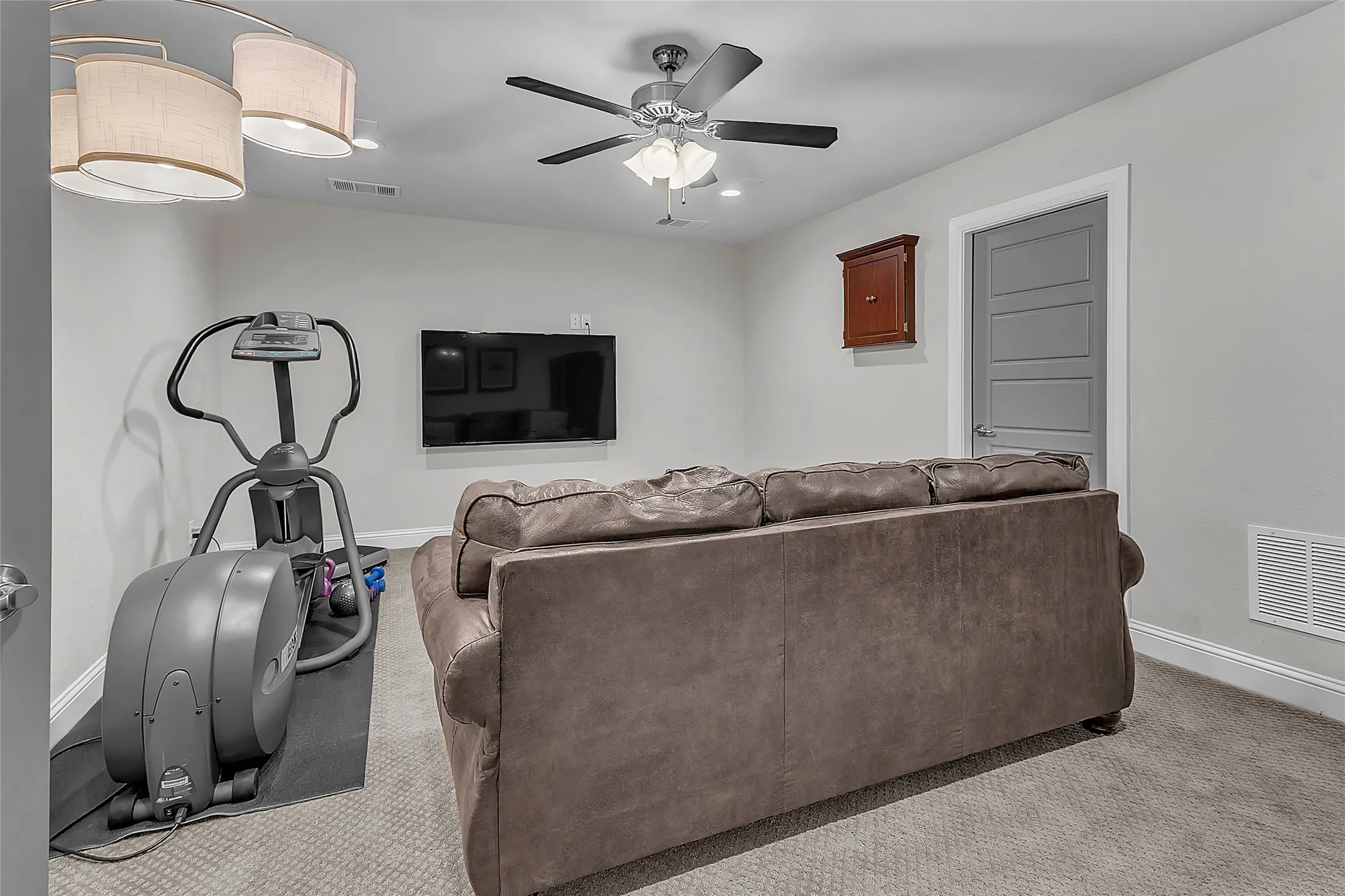Upstairs bonus room wired for surround sound featuring recessed lighting, ceiling fan, paneled doors, carpet, neutral paint and walk-in access to attic with subfloor. Could easily be a guest quarters, media or game room.