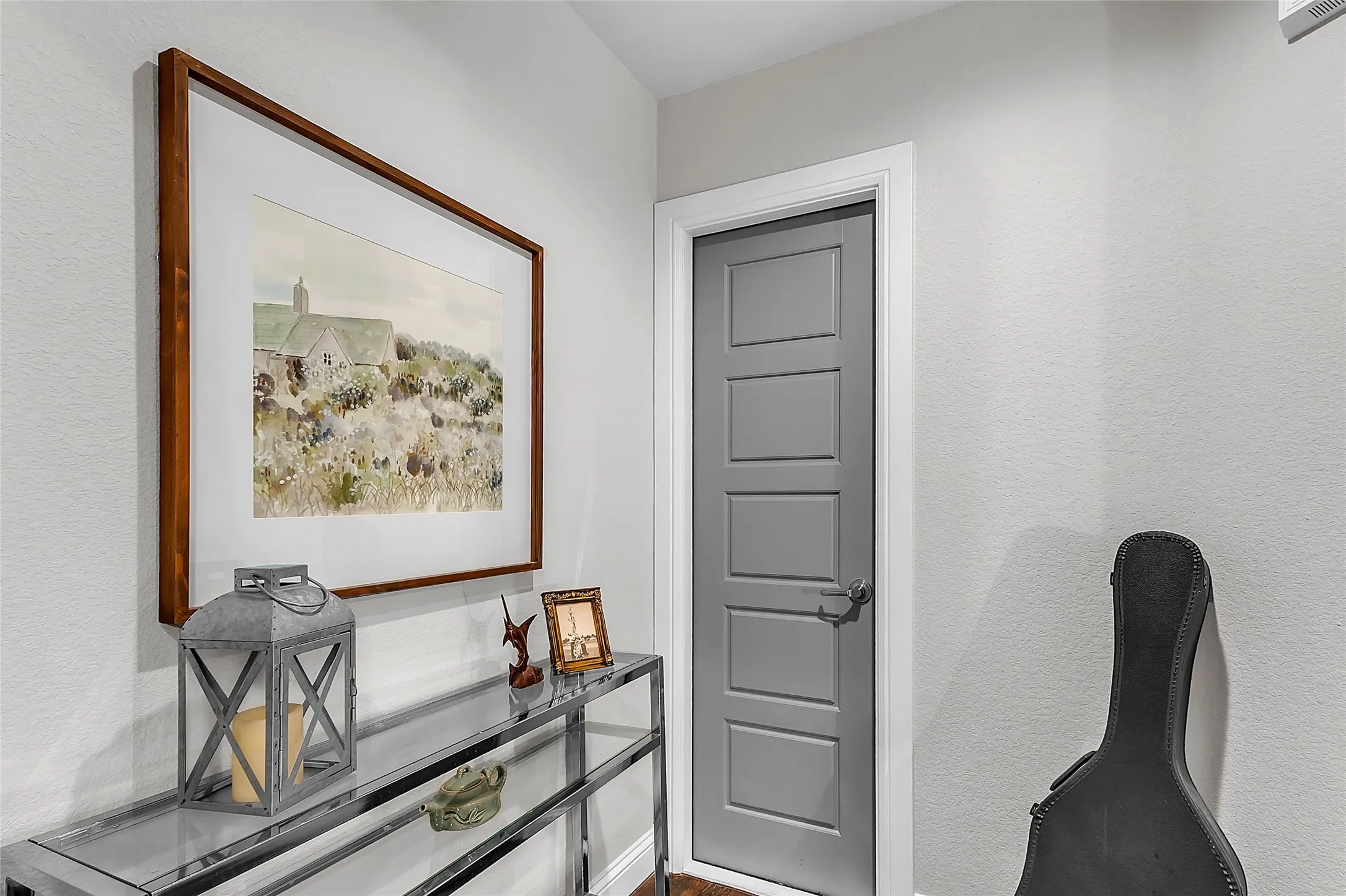 Landing at the top of the stairs showing a door leading to walk-in attic access with subfloor