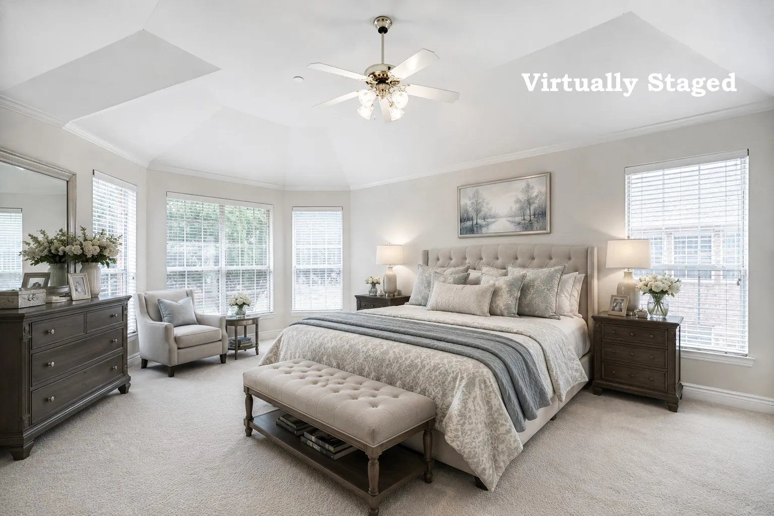 Room featuring a tray ceiling with a ceiling fan, bay windows, carpeted flooring, and neutral wall tones