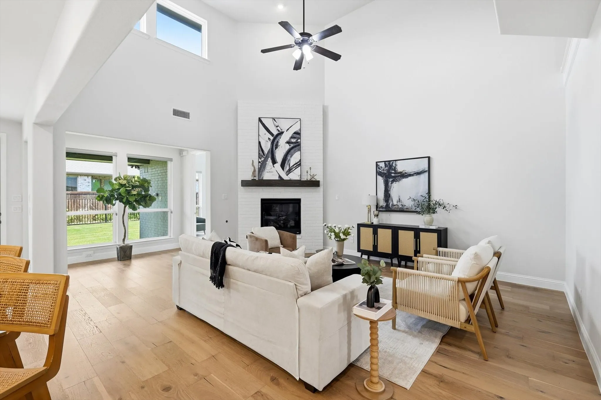 Expansive living area featuring soaring ceilings and wood-finish flooring