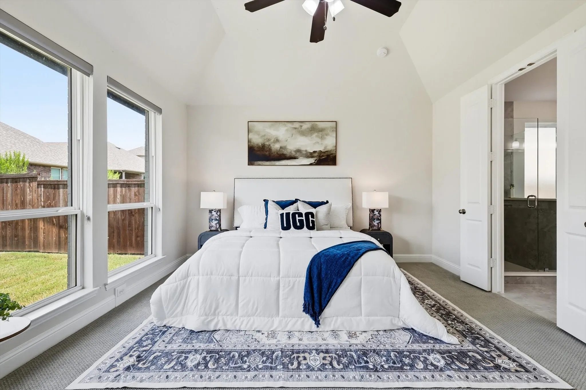 Bedroom featuring a vaulted ceiling and a dark wood-finish ceiling fan