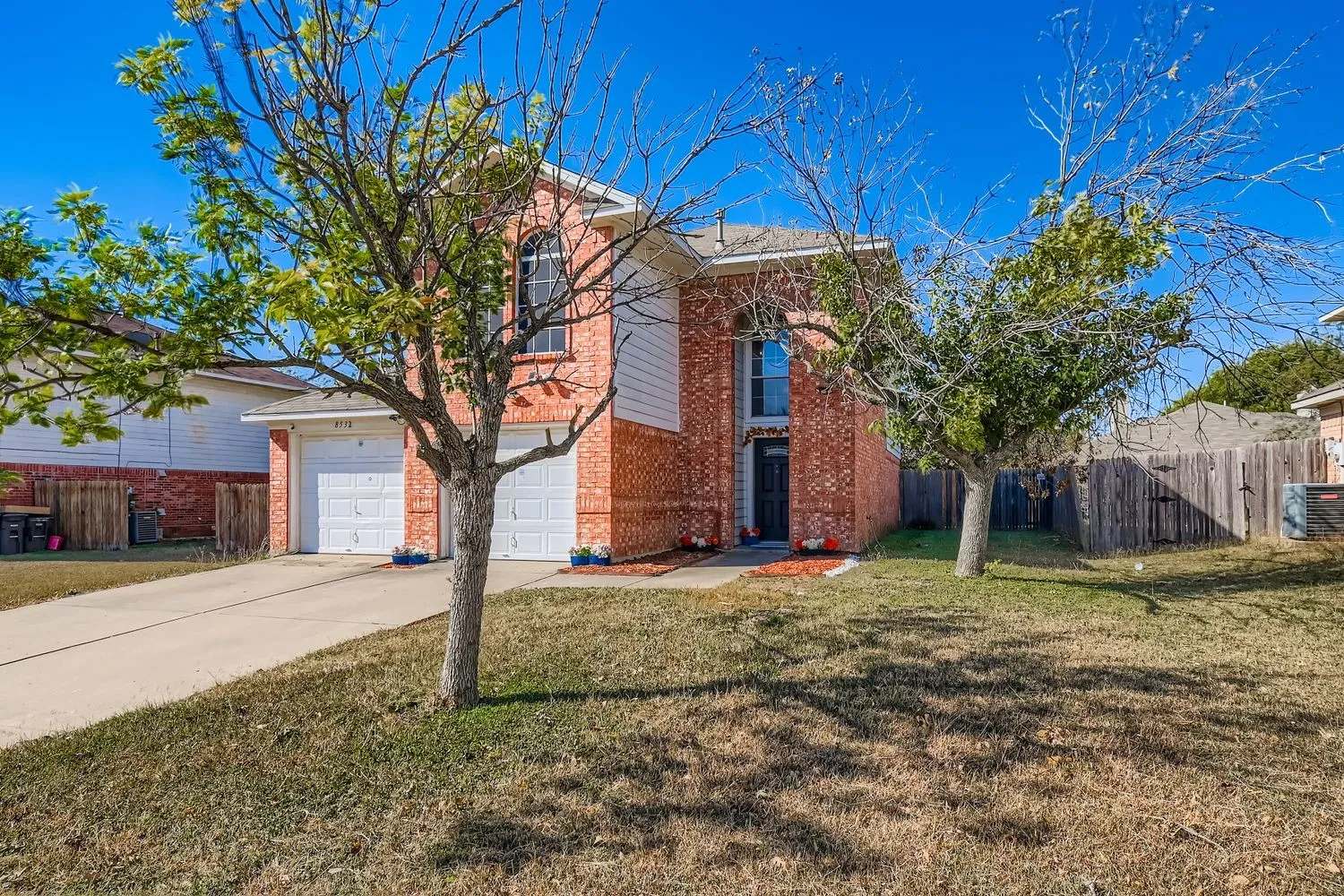 Brick and siding exterior with a two-car garage