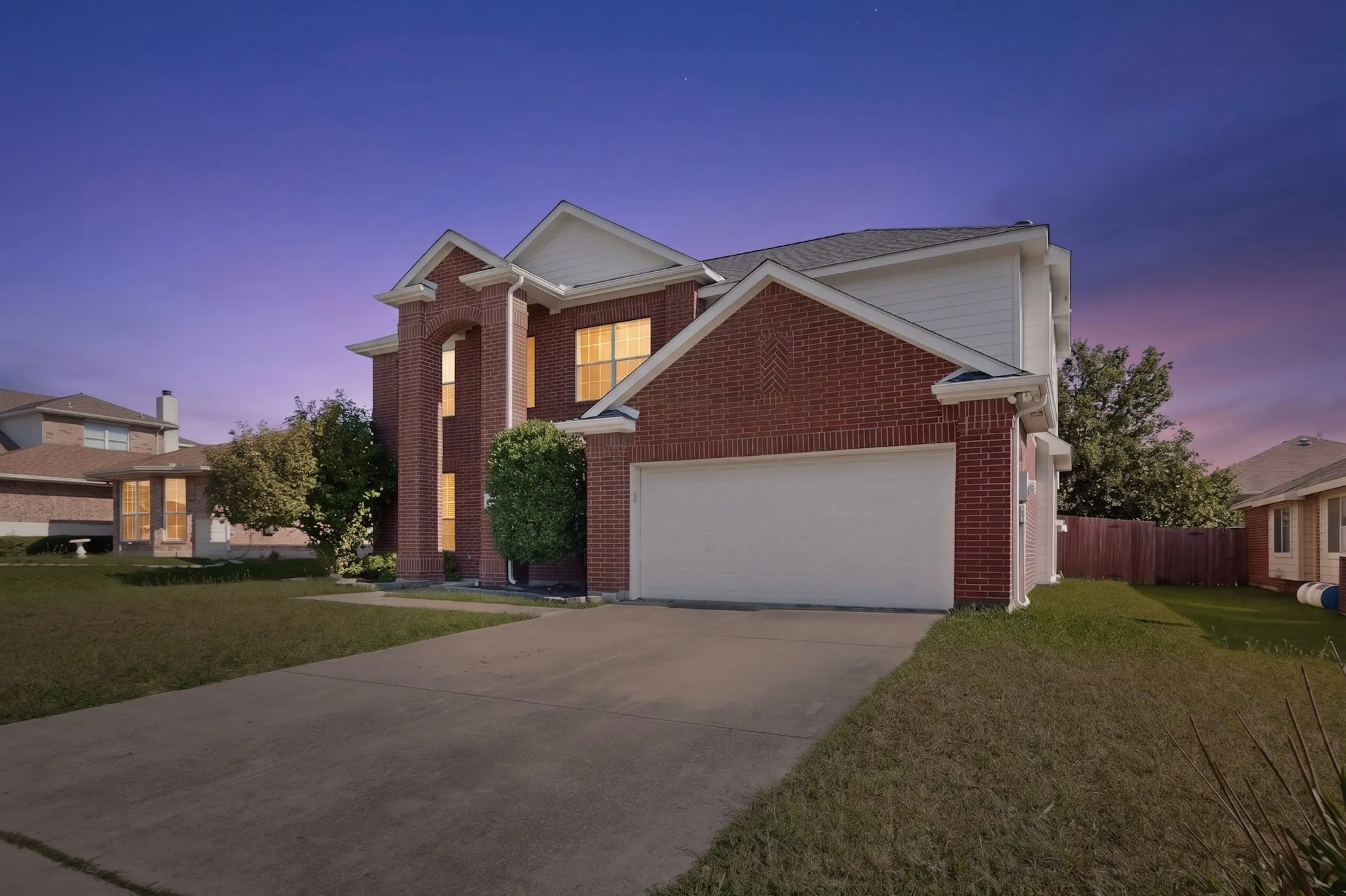 Twilight view of 604 Dyann Drive, showcasing the exterior lighting and architectural details at dusk.