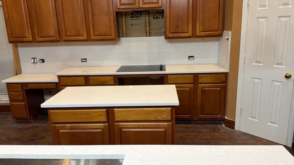 Kitchen featuring wood cabinetry, white countertops, and a central island