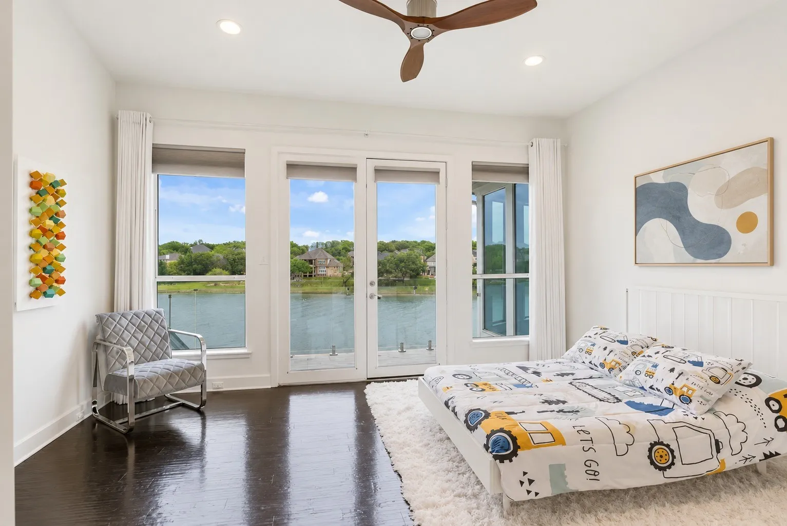 This bedroom offers private balcony access with serene water views-just like most of the bedrooms, which all face the lakefront.