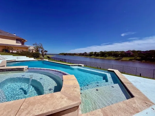 Unwind in your private pool and spa with tranquil lake views.