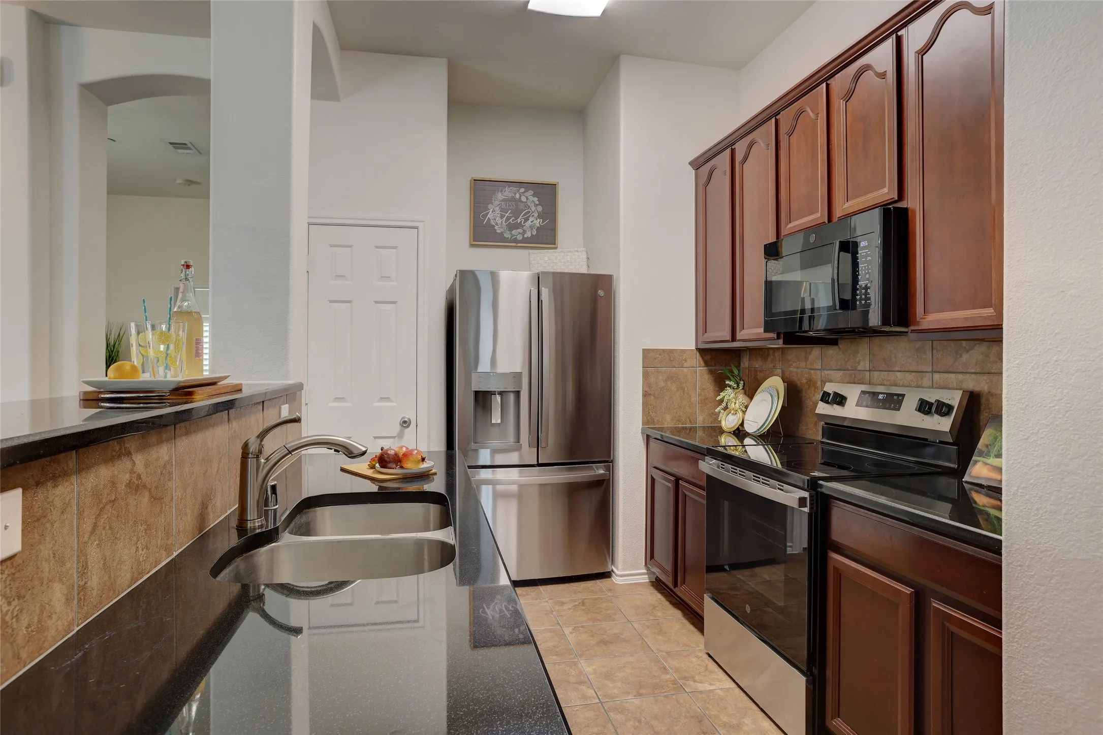 New stainless steel refrigerator, brand new range and microwave included in kitchen