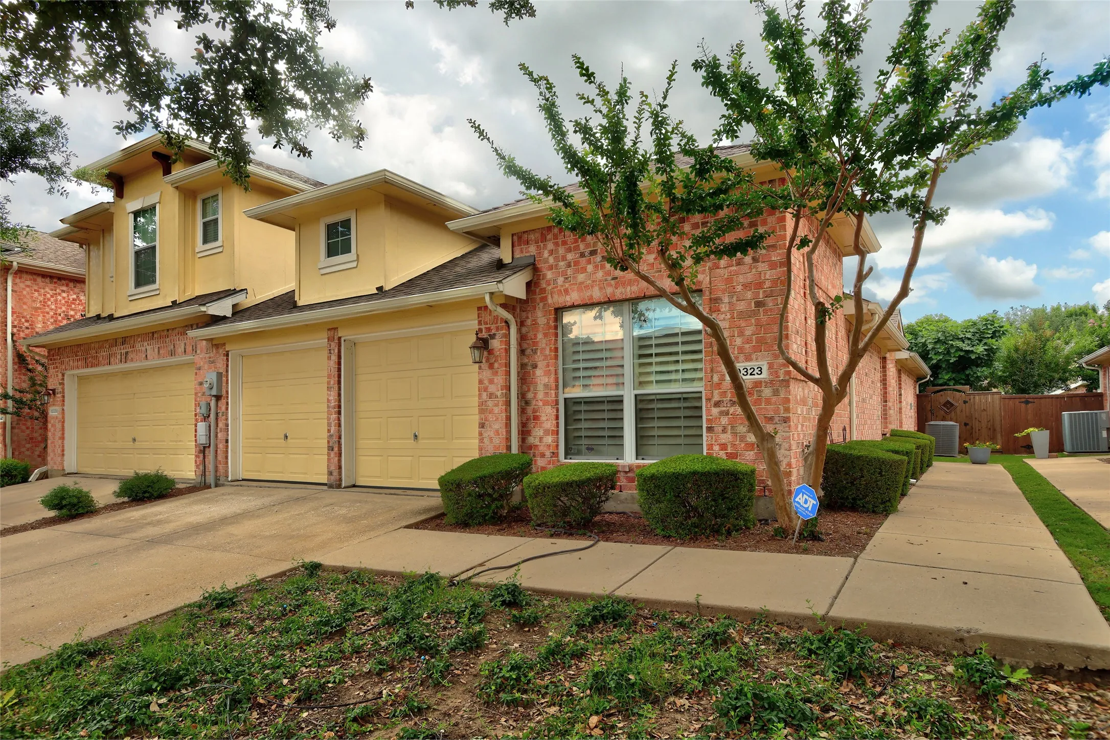 Private end unit with 2 car garage and additional driveway space for parking