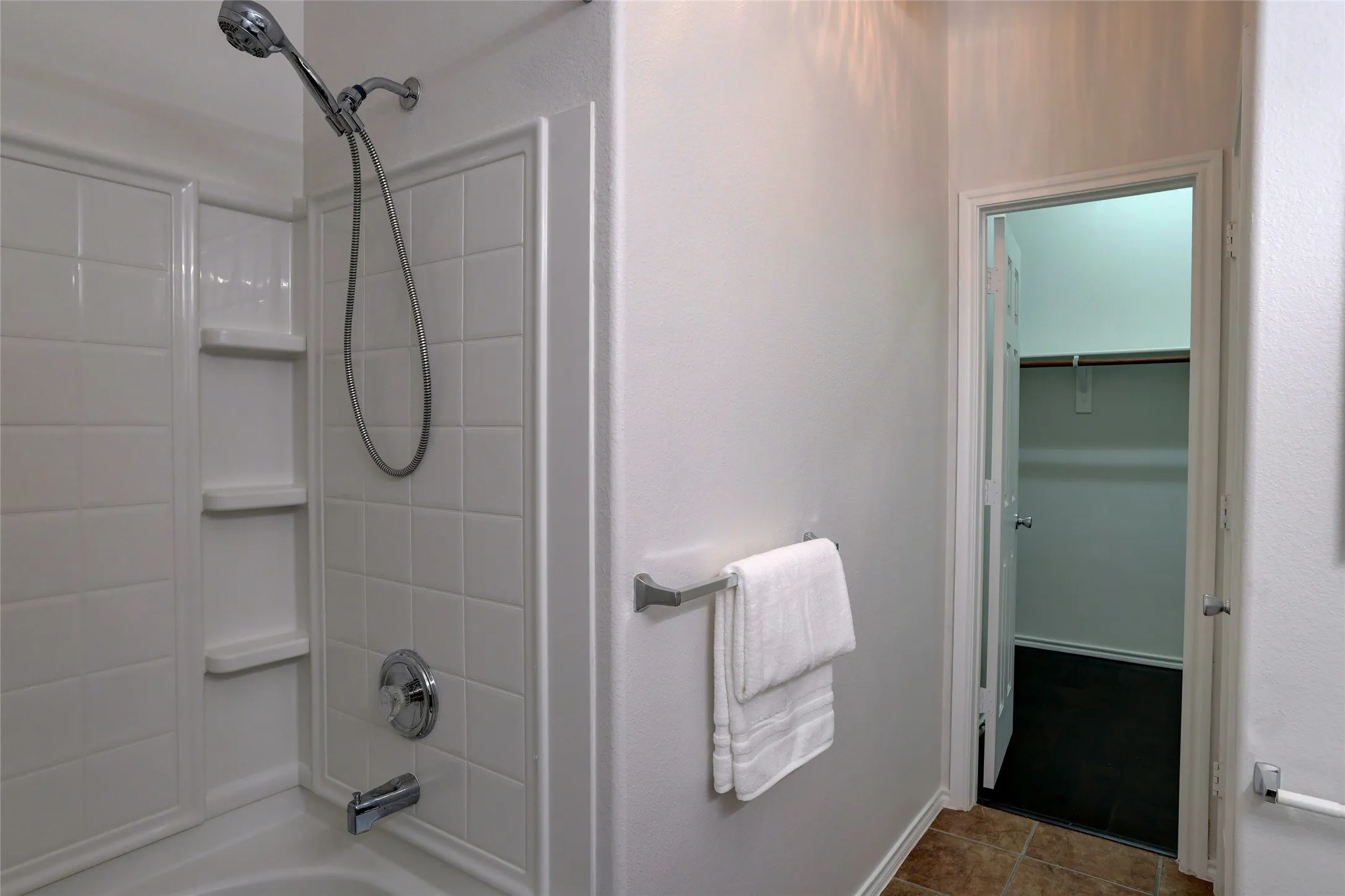 Primary bath with tub/shower combination with large linen closet and  walk in closet