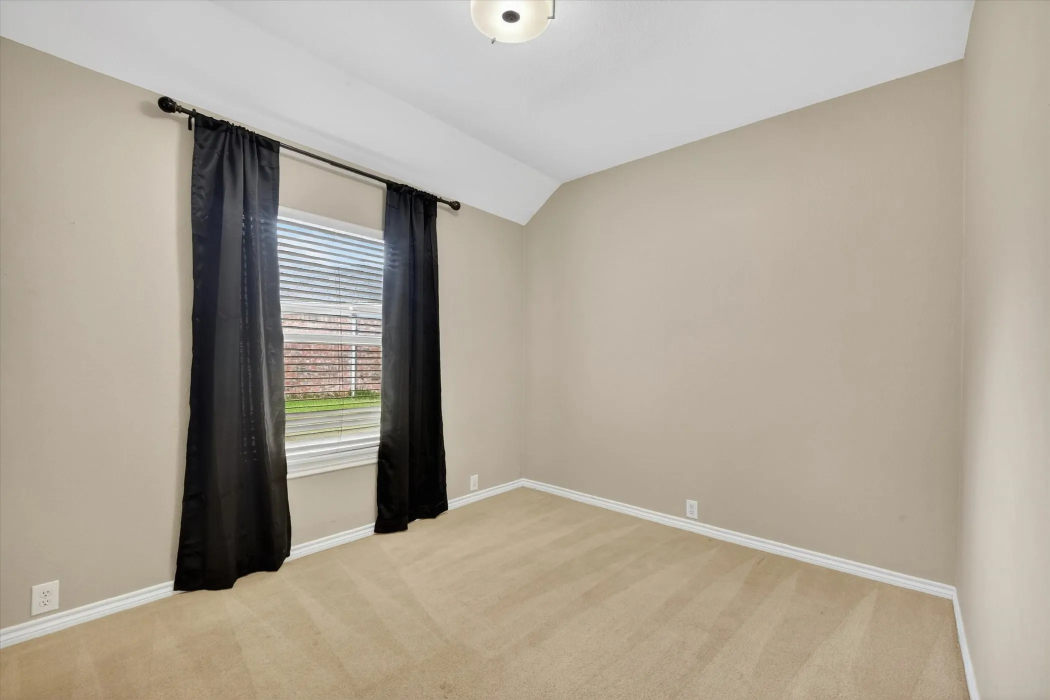 Neutral-toned walls complement the carpeted flooring