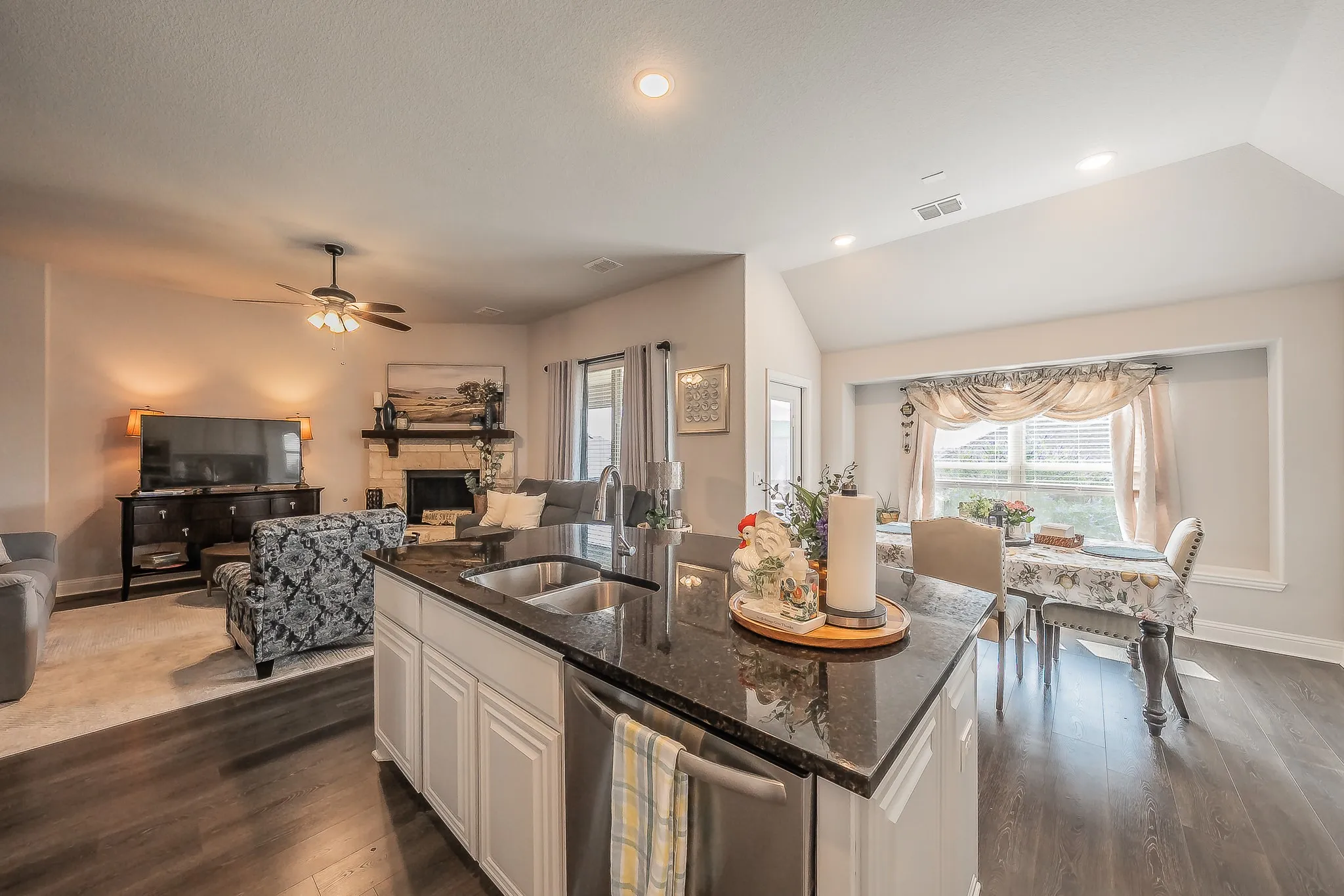 Kitchen island with a double basin sink and a granite countertop