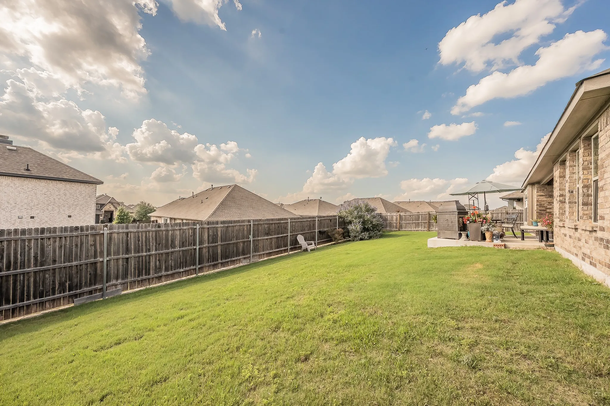 Expansive lawn area with a wood privacy fence