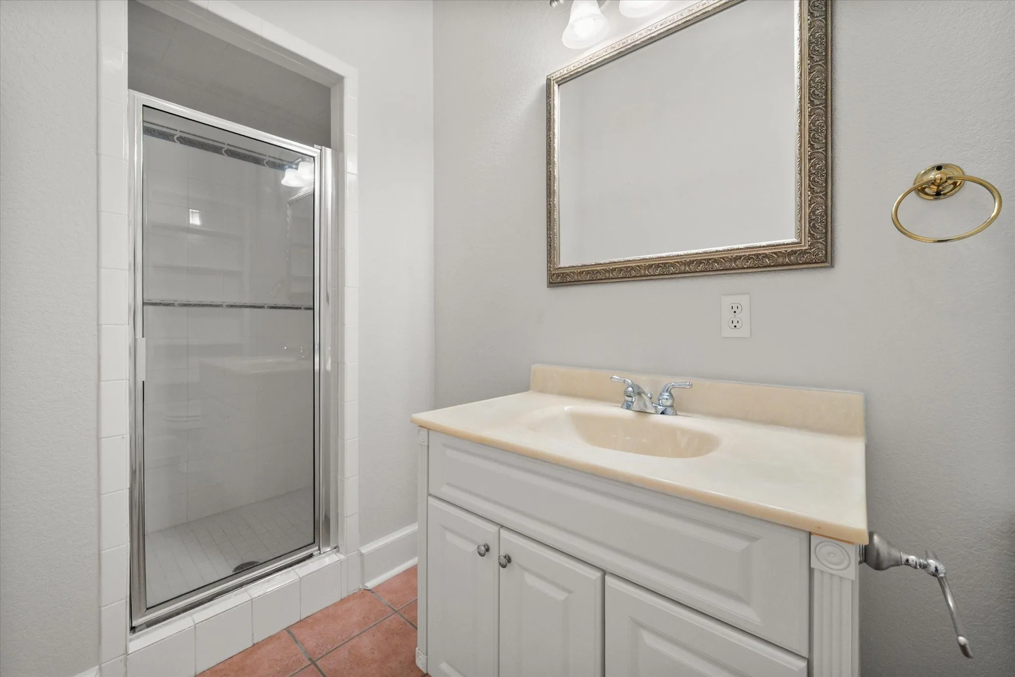 Full bathroom with walk-in shower, vanity, and clean functional layout in Kerens TX farmhouse.