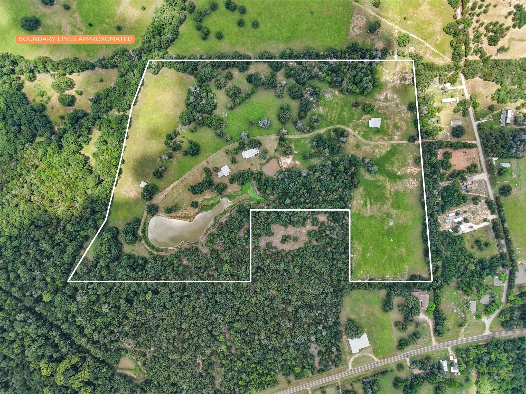 Aerial view of 42.199-acre Kerens ranch property with farmhouse, pond, pasture, trees, and room for livestock.