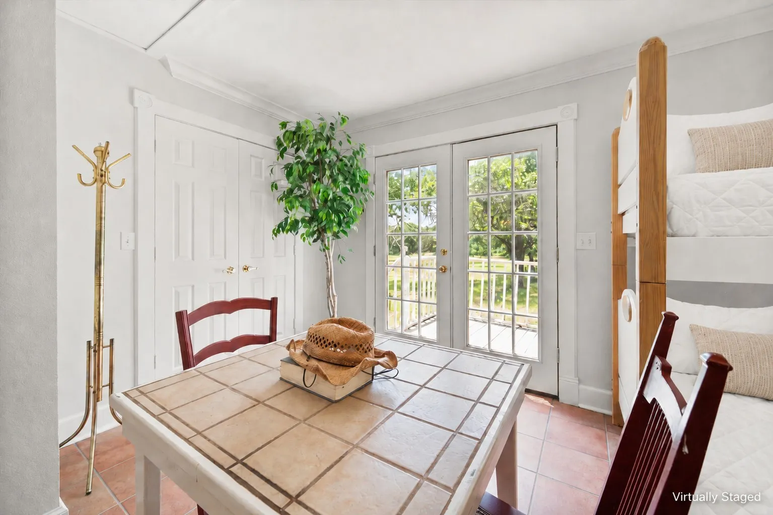 Bunkroom corner with French doors to deck and matching farmhouse bedding.