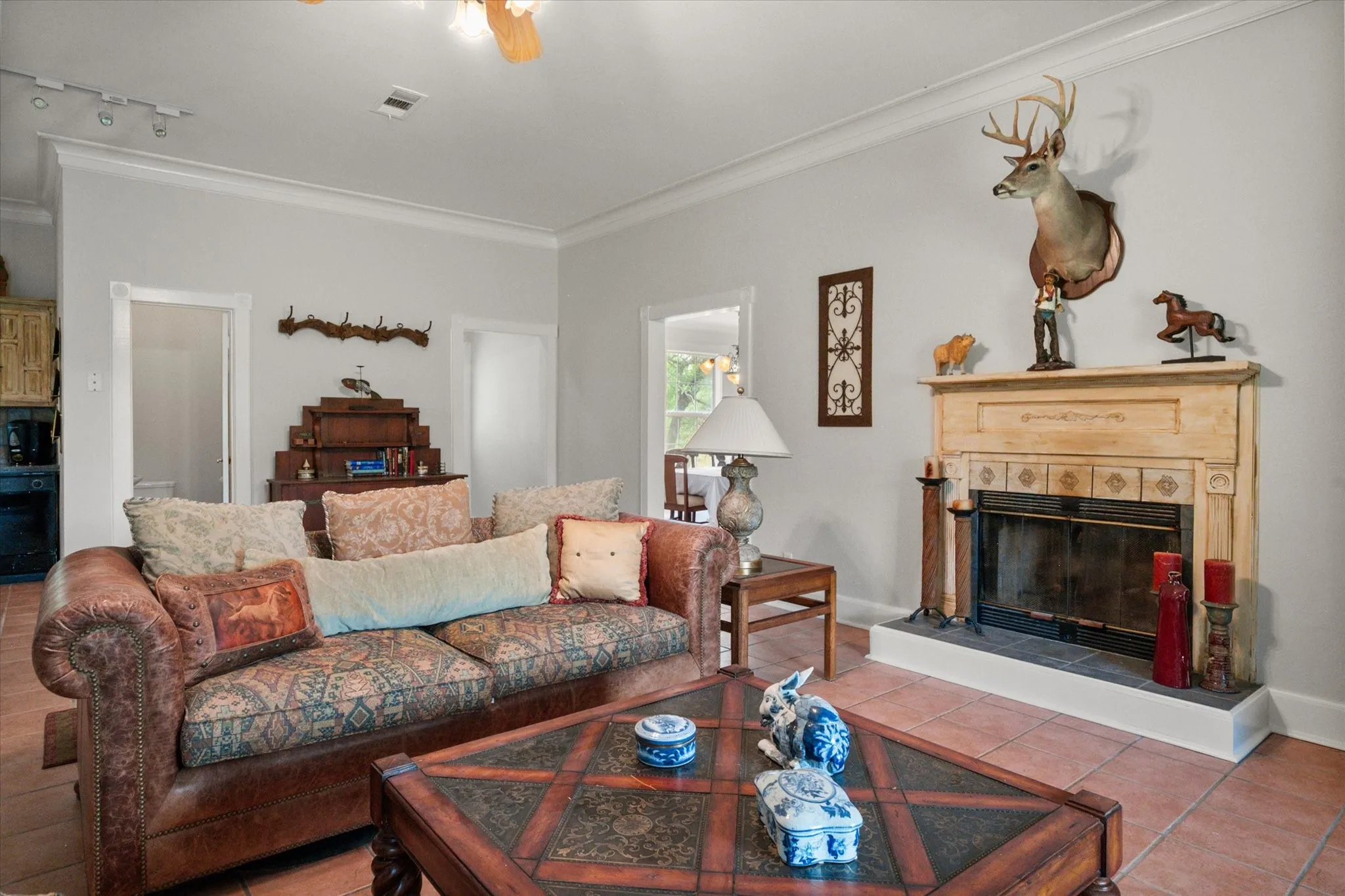 Spacious farmhouse living room with fireplace, tile floors, and inviting country charm near Corsicana and Dallas.