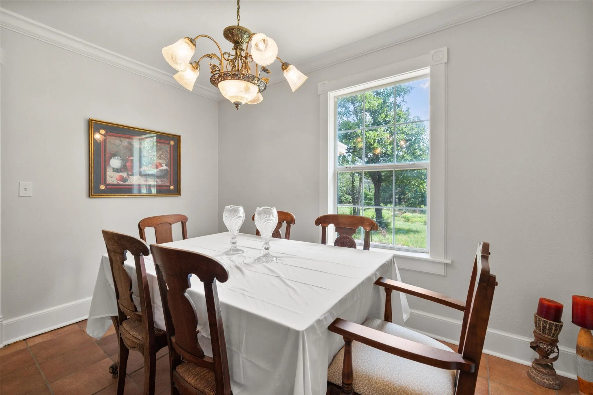 Dining room with natural light, tile flooring, and space for family meals in a 42-acre farmhouse retreat.