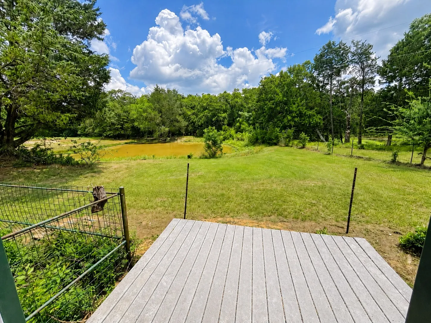 Peaceful pond adds country charm, recreatio, and wildlife views from the deck, on this 42-acre Kerens farm and ranch property.