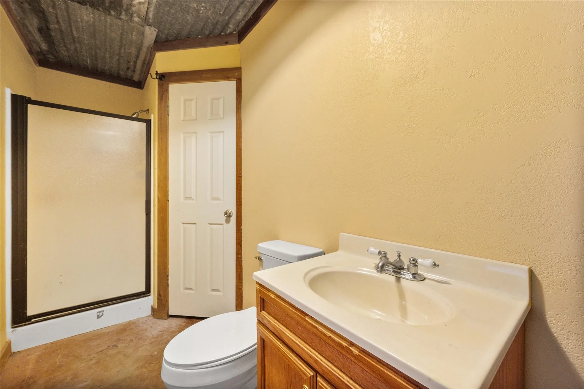 Bathroom inside barn efficiency apartment with sink, toilet, and private living-quarter convenience.